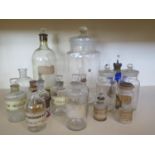 A small collection of 13 glass bottles and an oil lamp with blue reservoir