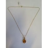 an 18ct yellow gold amber pendant marked 750, on a hallmarked 18ct chain, 44cm long, approx 3.8