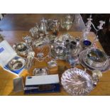 A large quantity of various plated wares, including a candelabra, some coffee and tea pots,