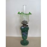 An oil lamp with enamel green glass body and green tinted shade, 60cm tall, good condition, minor