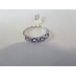 A hallmarked 9ct white gold tanzanite diamond ring, size P, approx 1.9 grams, new condition, ex