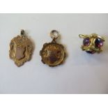Two hallmarked 9ct yellow gold watch chain medallions total weight approx 9.6 grams, and a gilt