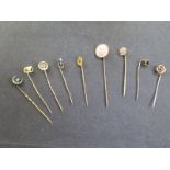 Nine tie pins to include two 15ct, approx 2.7 grams - one 10ct approx 1 gram, and a 9ct pin,