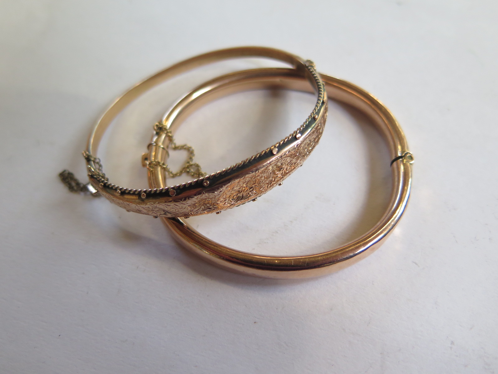 Two 9ct gold bangles, 6.5 x 5.5cm and 6.5 x 6cm, total weight approx 16.4 grams, dents to both ,