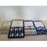 A set of six silver teaspoons, six enamel silver spoons, six enamel plated spoons and six plated