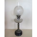 An oil lamp with an etched shade and cut clear glass font, 66cm tall, in good condition