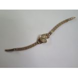 An 18ct yellow gold ladies manual wind MuDu wristwatch on a 9ct yellow gold strap, back has minor
