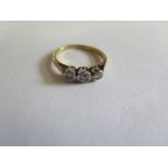 An 18ct and platinum three stone diamond ring, size L - approx 2.54 grams, some usage but