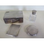 A silver desk cigarette box, a silver cigarette case, a silver compact and a silver top bottle