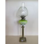 An oil lamp with enamel glass font and clear glass bell shaped shade, 73cm tall, slight wear to