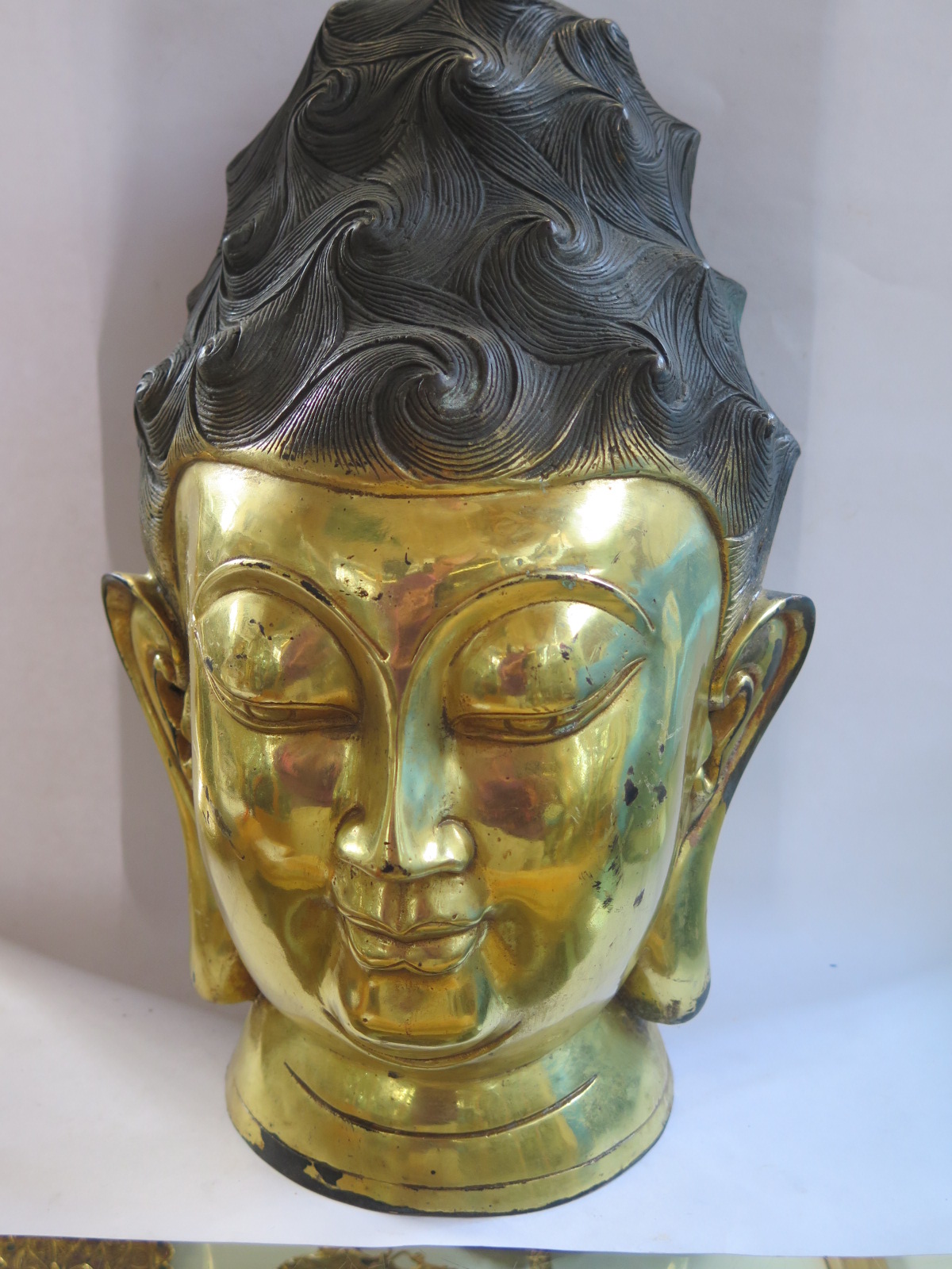 A gilt bronze Chinese Buddha head, 34cm tall, no obvious damage, with aged finish