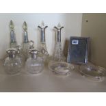 A collection of nine silver top and rimmed bottles, tallest 22cm, a small silver frame, 15x11cm