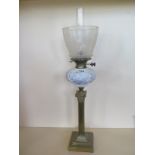 An oil lamp with an etched shade and moulded glass font, 80cm tall