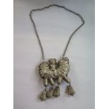 An Oriental white metal bell pendant necklace - 41cm long - good condition