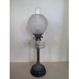 An oil lamp with clear glass font and etched globe shade, 65cm tall, generally good