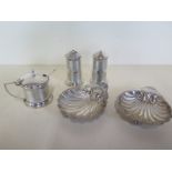 A silver three piece cruet with plastic liners and two silver shell dishes, approx 1.9 troy oz -