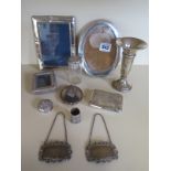 Three silver photograph frames, a silver weighted vase, a silver cigarette case, two silver decanter