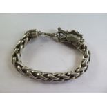 An Oriental white metal dragon bracelet 21cm long