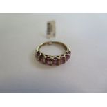 A hallmarked 9ct yellow gold pink topaz half eternity ring - size O - approx 2.7 grams - new