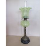 An oil lamp with stripped vaseline glass shade and font - 72cm tall, minor chips to base of shade,