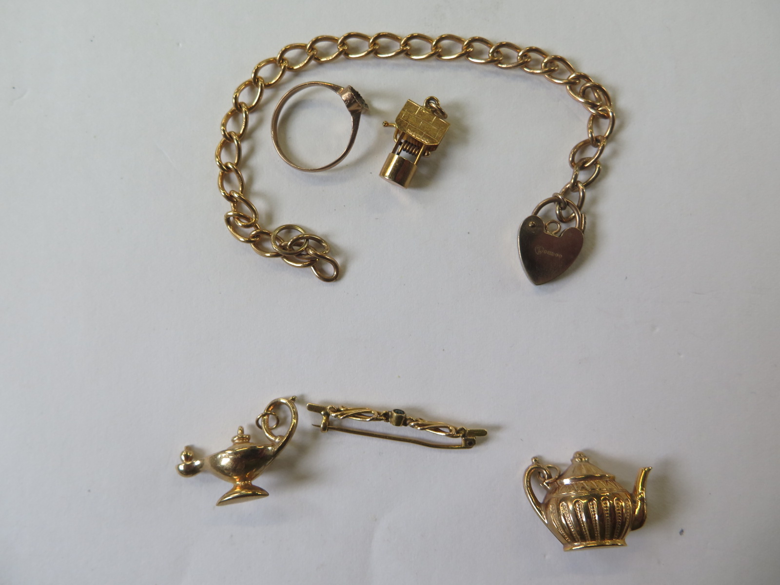 A 9ct hallmarked gold chain, 17cm long, a hallmarked 9ct gold charm, a 9ct gold ring missing its