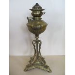 A brass triform oil lamp base, 56cm tall, overall good