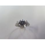 A platinum solitaire dress ring incorporating one round transitional brilliant cut diamond,