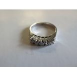 An 18ct white gold five stone diamond ring, each stone approx five points - total approx 0.25 ct -