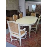 A shabby chic set of table and chairs, the chairs with woven cane backs and seats and include two