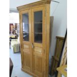 A 19th Century style pine corner cupboard with two doors and four internal shelves, 220cm x 120cm