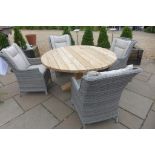 A Bramblecrest Kuta 145cm round table with four dining armchairs in grey coloured all weather wicker