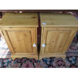 A pair of modern pine bedside cabinets with ceramic handles, approximately 59cm high, 38cm wide 29cm