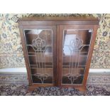 A Circa 1930's oak lead glazed cabinet bookcase with adjustable shelves 116cm tall x 90cm x 23cm -