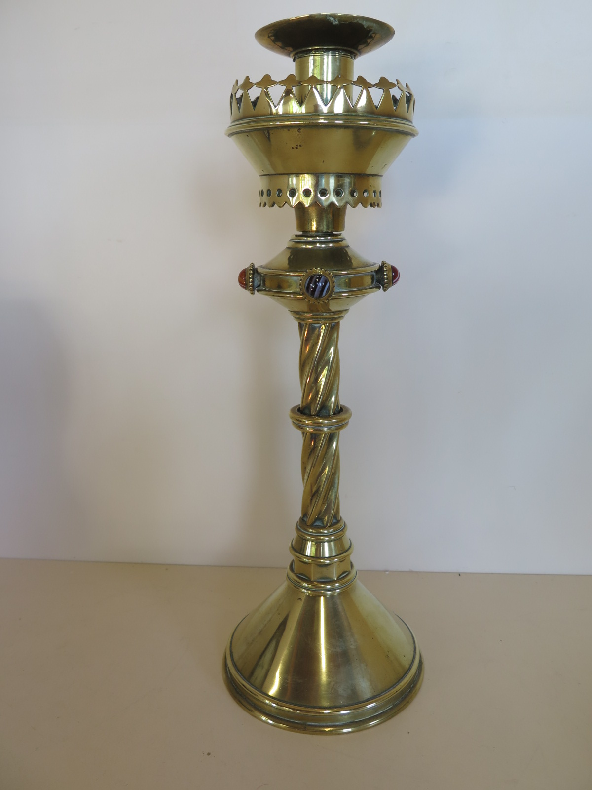 A Pugin design brass candle stick with agate roundels, 39cm H, some bending but generally good