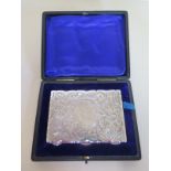 An ornate silver card case with original box - Birmingham 1904/05 10cm x 7cm - approx weight 3