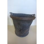 A Georgian leather fire bucket with cast iron handle, and metal rivets, approximately 26cm high
