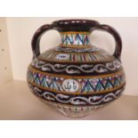 An Islamic type twin handled pot, 36cm H x 36cm D, chip to rim, otherwise good