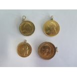 Two Gold sovereigns and two gold half sovereigns - one sovereign dated 1911 with a 9ct mount, the