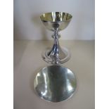 A 20th century communion silver chalice, consecrated in 1955 together with a silver dish and