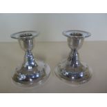 A pair weighted silver dwarf candlesticks 8.5cm tall