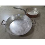 A copper frying pan together with a twin handles copper pan