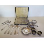 A collection of silverware, including six Georgian teaspoons, three napkin rings, a cased set of