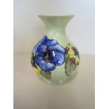 A Moorcroft pottery vase decorated with pansies on a yellow ground - signed K - height 13cm -