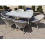 A Bramblecrest Stockholm Rattan table and six chairs with cushions