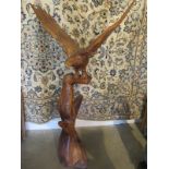 A carved wooden eagle on a branch - 150cm H