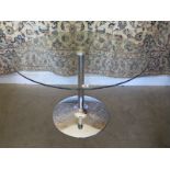 A contemporary glass topped bistro style table with chrome support and bass, diameter