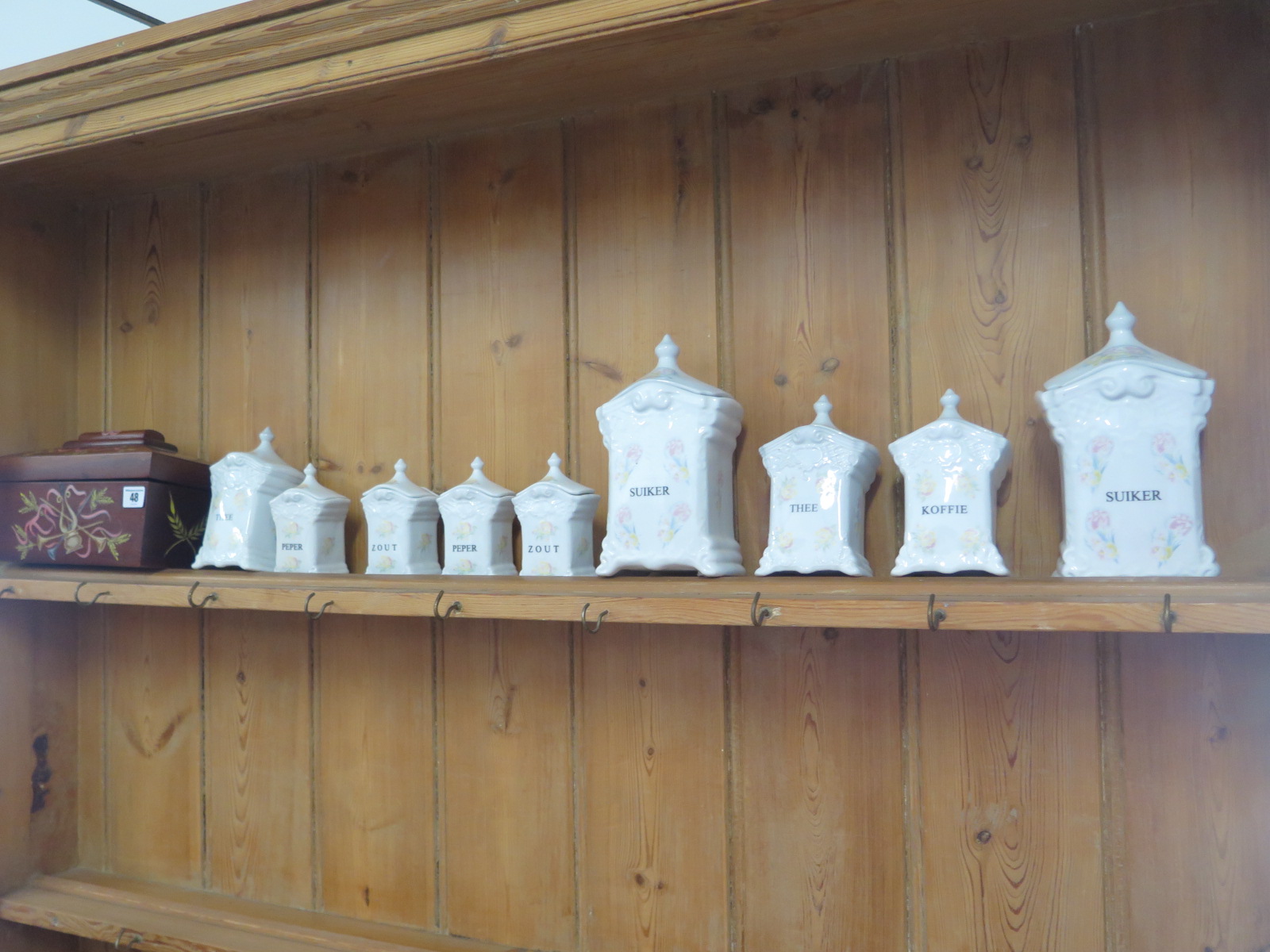 Nine ceramic containers and a decorated tea caddy