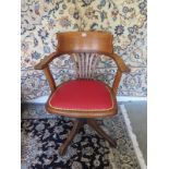 An early 20th century, swivel office chair with upholstered seat, in a restored and clean condition