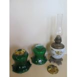 An oil lamp - 54cm H including chimney, and two green glass shades with galleries - 20cm H