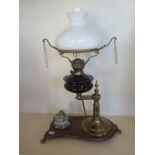 A Victorian oil lamp and ink well on stand, the lamp with a shade and chimney, and cut glass